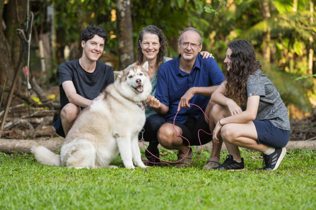 Family with man, woman, two teenagers and a husky dog